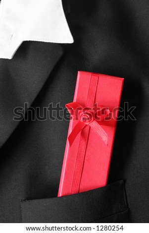 Dinner jacket pocket with red gift box