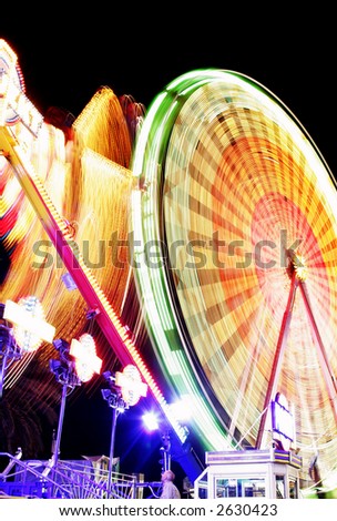 Night time motion blur with spinning ferris wheel
