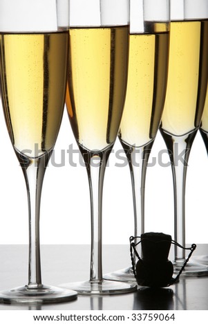 Champagne glasses and a cork in silhouette