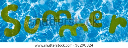 Summer written in letters  cut out of banana leaf floating in a swimming pool