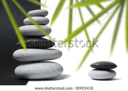 Black and white pebbles arranged in stacks with nice balance and a split black and white background