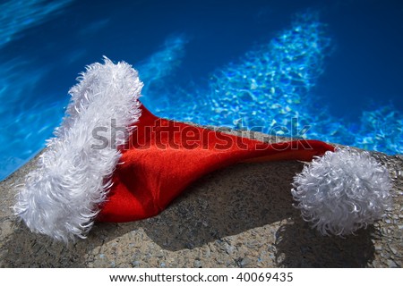 Nice santa hat by a blue swimming pool