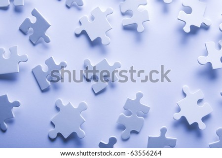 Puzzle pieces in high key with a space for copy