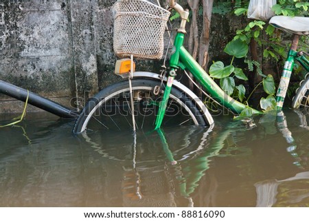 BANGKOK THAILAND - SEP 13:The water level up to 60-70 cm, making it impossible to use a bicycle in traffic. Flood event on September 13,2011 Soi Raminthra 109, Bangkok Thailand