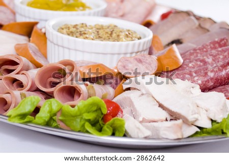 Cold meat catering platter with sliced chicken breast, mortadella, salami, roast beef, ham, turkey, kabana sausage and seeded wholegrain mustard and sweet mustard pickle.