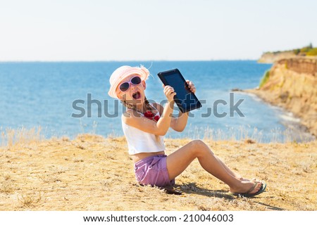 crying girl on the beach with laptop