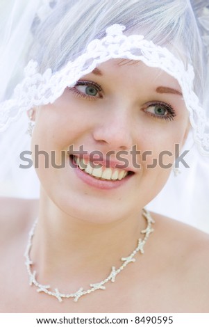 happy bride with a veil and a beautiful neck necklace