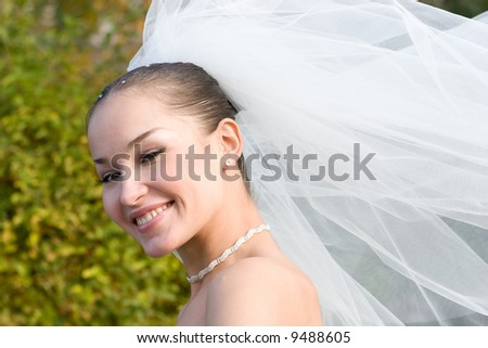 a happy bride and a flying downwind veil