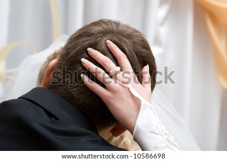 woman kisses the man and embra?e his head with her hand