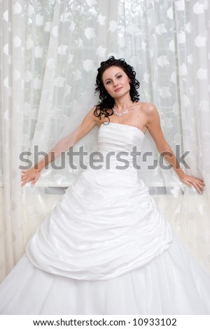stock photo beautiful girl in wedding dress stands by the window