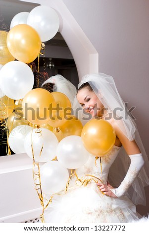 pretty bride and white and golden balloons