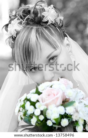 bride in black and white with a flower bouquet in color