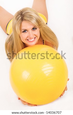 happy girl with fitness ball on the floor