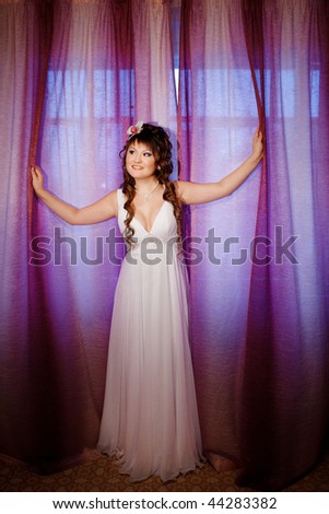 bride near the window with curtains