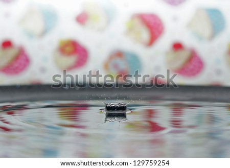 Colourful macro water drops splashing  against vibrant colored backdrop, isolated droplets