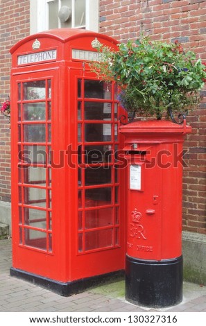 Traditional post box and phone box in England, in red colour