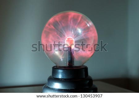 Glowing plasma ball in dim lighting