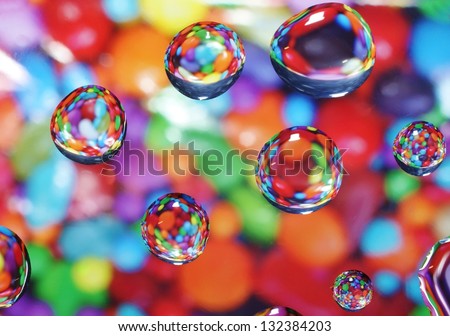 Sweet candy background with water drops reflecting and magnifying the sweets
