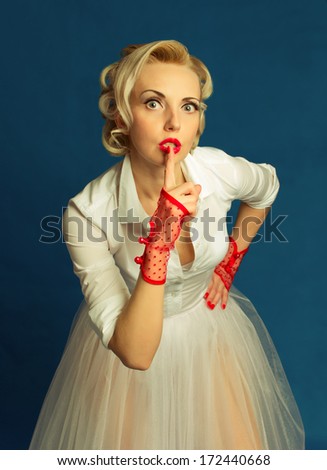 woman making a secret gesture with his finger in the mouth