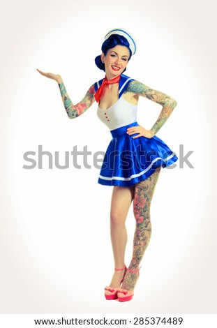 Pin-up girl sailor to his full height, hand shows a demonstrative gesture
