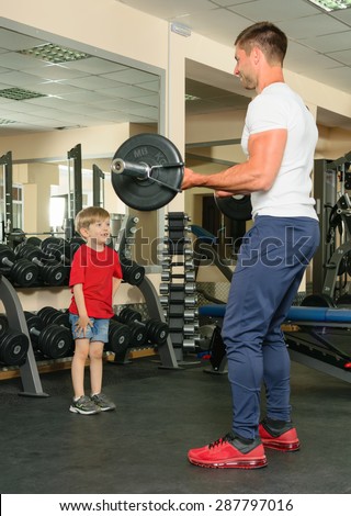 Pope shows little son how to lift weights in the gym