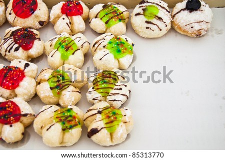Row of fancy bread with icing and  jelly surface for sale and marketing