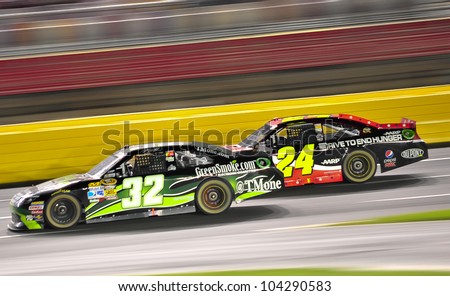 CHARLOTTE, NC - MAY 27:  Jeff Gordon 24 is passing TJ Bell 32 at the Nascar Coca Cola 600  at Charlotte Motorspeedway in Charlotte, NC on May 27, 2012
