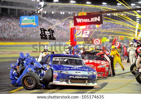 CHARLOTTE, NC - MAY 27:   pit stops for Aric Almirola (blue) and Tony Stewart at the Nascar Coca Cola 600  at Charlotte Motorspeedway in Charlotte, NC on May 27, 2012