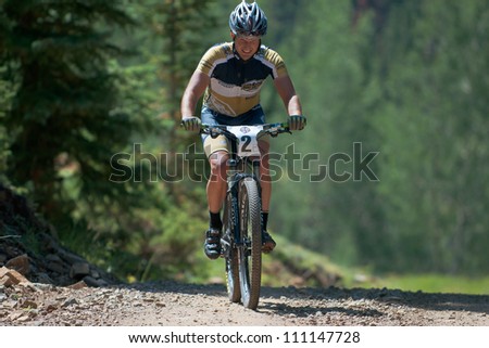 ASPEN, CO - AUG 25: Joel Mischke uphill at The Power of Four mountain bike race in Aspen, CO on Aug 25, 2012