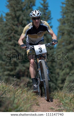 ASPEN, CO - AUG 25: Michael Tierney, downhill at The Power of Four mountain bike race in Aspen, CO on Aug 25, 2012