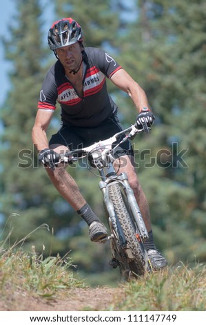 ASPEN, CO - AUG 25: Justin Labier downhill at The Power of Four mountain bike race in Aspen, CO on Aug 25, 2012