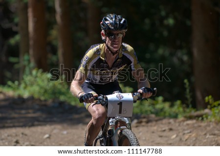 ASPEN, CO - AUG 25: Charlie Eckart uphill at The Power of Four mountain bike race in Aspen, CO on Aug 25, 2012