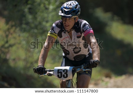 ASPEN, CO - AUG 25: Bill Madsen uphill at The Power of Four mountain bike race in Aspen, CO on Aug 25, 2012