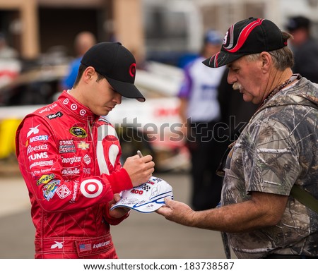 FONTANA, CA - MAR 22:Kyle Larson signing autograph at the  Nascar Sprint Cup Auto Club 400 practice at Auto Club Speedway in Fontana, CA on March 22, 2014