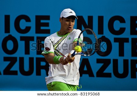 NICE, FRANCE - MAY 17: Italian tennis player Fabio Fognini hits a backhand ball against latvian Ernests Gulbis at the 2011 ATP Nice Cote d\'Azur Open tennis tournament on May 17, 2011 in Nice, France