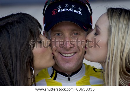 DENVER, CO - AUG 28: Winner Levi Leipheimer is congratulated by the honor girls on the podium of the 2011 USA Pro Cycling Challenge in Denver, Colorado on Aug 28, 2011