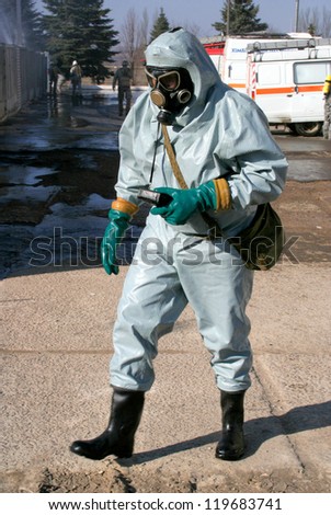 Man in chemical protection suit, carrying out the decontamination area