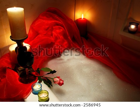 bathtub surrounded with candles, romantic atmosphere