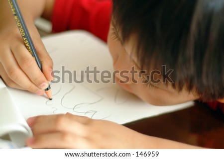 Five-year old Chinese boy learning to write in Penang, Malaysia