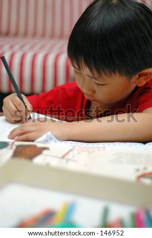 Five-year old Chinese boy learning to write in Penang, Malaysia
