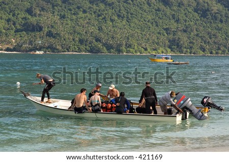 Divers on a boat heading for a dive site