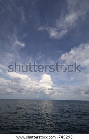 Blue sky, clouds and ocean horizon seen from a liveaboard dive boat
