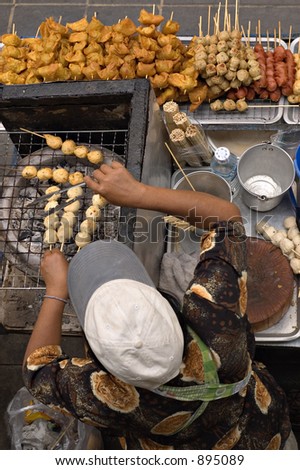 Street hawker selling skewered fish balls, pork balls etc in Bangkok, Thailand
