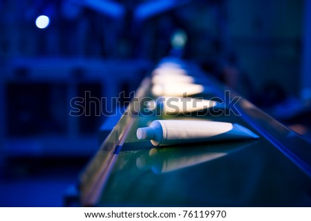Toothpaste tubes on conveyor belt