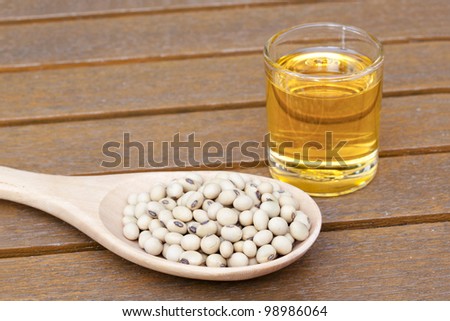 Soy bean and oil on a teak table