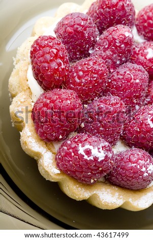 Delicious dessert fresh raspberry fruit tart pastry on a plate
