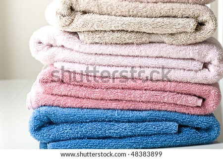 Colorful towels folded on a table close up