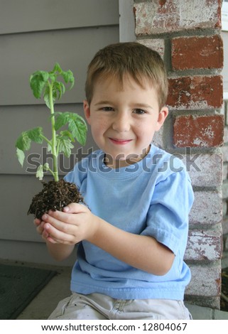 A Healthy Growing boy holds a healthy growing plant