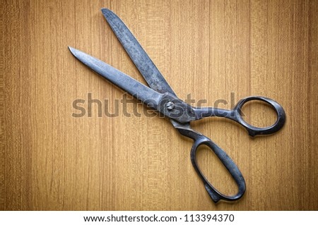 Old tailors scissors on wood background