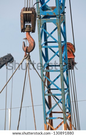 Weathered crane hook detail with hanging load